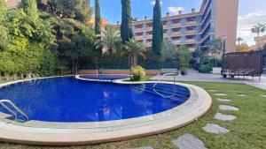 a swimming pool in a yard with a building at Albir Beach Apt in Albir