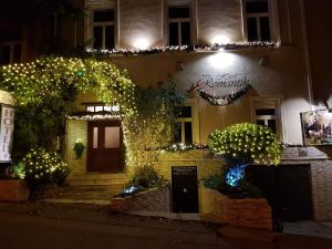 a building with christmas lights in front of it at Hotel Romantik Eger in Eger