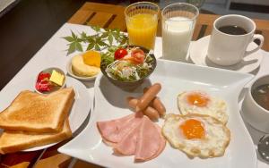 a plate of breakfast food with toast and eggs at Fuji Elegance Hotel in Yamanakako