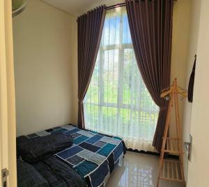 a bedroom with a bed and a large window at Villa Srikandi Rayya A8 in Tlekung +8 photos