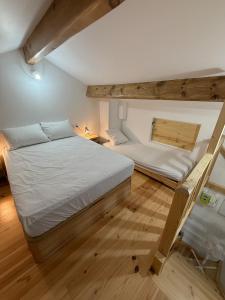 a bedroom with two beds in a room at Cozy Lac - Puyvalador in Puyvalador
