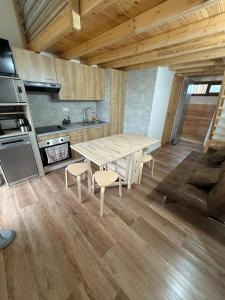 a kitchen with a table and chairs in a room at Cozy Lac - Puyvalador in Puyvalador