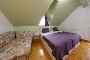 a bedroom with a bed and a couch at Casa la Martin in Comarnic