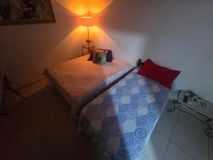 1 dormitorio con 1 cama con lámpara en la pared en Fort 3, en Angra dos Reis