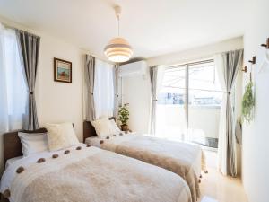 En eller flere senge i et værelse på tazuraya-sakuramachi-一棟貸切-無料駐車場