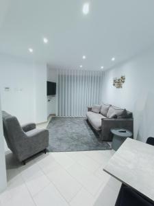 a living room with a couch and a chair at Albir Beach Apt in Albir