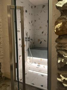 a shower with a glass door in a bathroom at Una piccola bomboniera in Gaby +11 photos