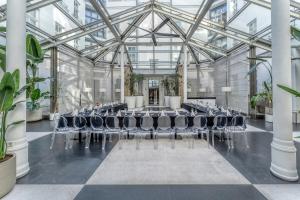 a conference room with chairs in a glass building at H15 Boutique Hotel, Warsaw, a Member of Design Hotels in Warsaw