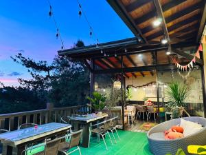 a patio with tables and chairs on a deck at Yue Ya Villa in Puli