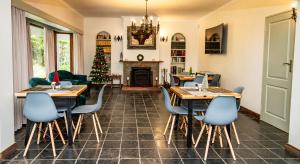 a living room with tables and a christmas tree at House 1967 in George