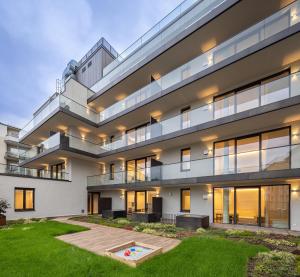 an exterior view of a building with a yard at BLOOM-Living in Linz