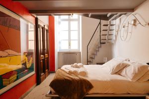 a bedroom with a bed and a staircase at Carlo Alberto CHARM & TERRACE in Turin