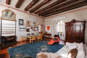 a living room with a white couch and a table at Carlo Alberto CHARM & TERRACE - Free Parking in Turin +44 photos