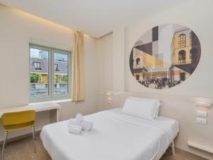a bedroom with a bed and a desk and a window at B&B Hotel Milano Central Station in Milan +26 photos
