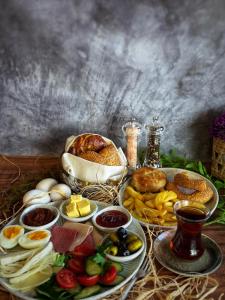 a table topped with different types of food on plates at Elysian Airport Hotel & Restaurant in Arnavutköy