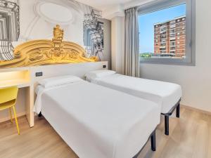 Ένα ή περισσότερα κρεβάτια σε δωμάτιο στο B&B HOTEL Torino Orbassano