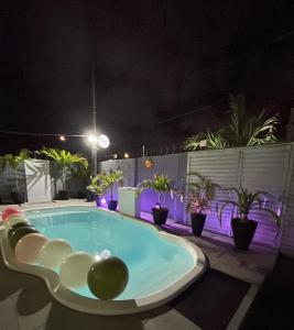 a hot tub on a patio at night at Garden JP in João Pessoa +64 photos
