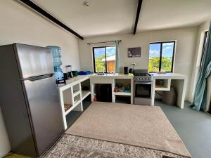 a kitchen with a stainless steel refrigerator and counters at Stella Mar Oceanfront Hotel in Popoyo +117 photos