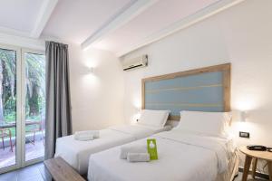 a hotel room with two beds and a balcony at B&B HOTEL Ischia San Nicola in Ischia