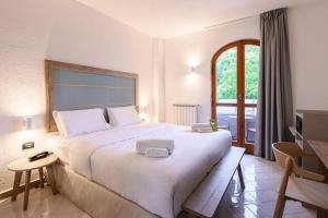 a bedroom with a large white bed and a window at B&B HOTEL Ischia San Nicola in Ischia +36 photos