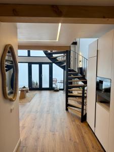 a living room with a staircase in a house at Altitude Escape Retreat in Fundata