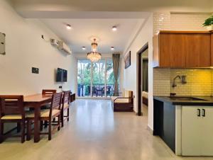 a kitchen and dining room with a table and chairs at Tranquill riverview resort by trideus-Saipem, Candolim in Candolim