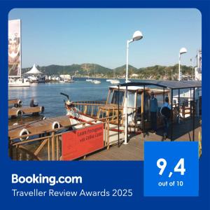 a boat is docked at a dock on the water at Lagoa Center House in Florianópolis