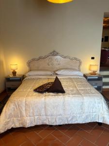 a bedroom with a large bed with two night stands at Borgo La Valle in Palazzo del Pero