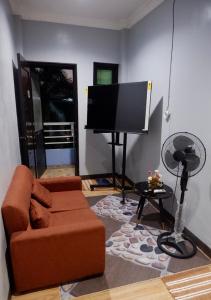 a living room with a couch and a flat screen tv at Arcova Residences 2BR Apartment in San Carlos +8 photos