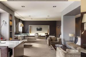 a living room with couches and chairs and a table at B&B Hotel Arezzo in Arezzo +23 photos