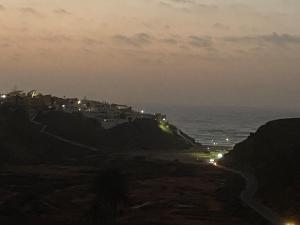 a view of the ocean at night at Beautiful view apartment in Mirleft