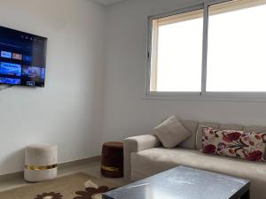 a living room with a couch and a window at Beautiful view apartment in Mirleft