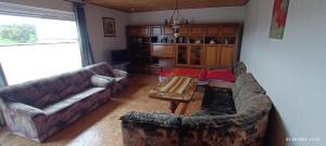 a living room with two couches and a coffee table at Albferienhaus Schaette in Giengen an der Brenz