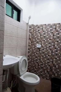 a bathroom with a toilet and a sink at Arcova Residences 2BR Apartment in San Carlos +8 photos