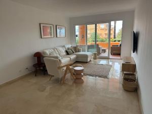 a living room with a couch and a table at Los Granados Stunning 2 Bed Beach Apartment in San Luis de Sabinillas