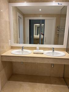 a bathroom with two sinks and a large mirror at Los Granados Stunning 2 Bed Beach Apartment in San Luis de Sabinillas +10 photos