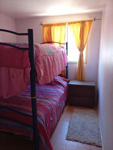 a bedroom with two bunk beds and a window at Litoral in Las Cruces