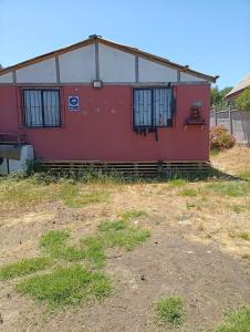 a red and white building with barred windows at Litoral in Las Cruces
