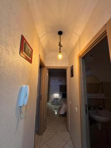 a hallway with a phone hanging on a wall at Appartement saada Agadir in Agadir