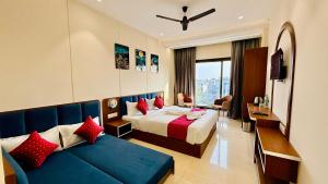 a hotel room with a bed and a couch at Hotel Mantri Ji in Ujjain