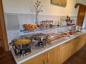 a kitchen with two large pots of food on a counter at Naturparkhotel Florence in Weissenbach am Lech