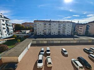 a parking lot with a bunch of parked cars at Mavin Apartments Cuneo in Cuneo