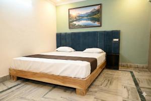 a bedroom with a bed with a picture on the wall at Nilaya in Varanasi +13 photos