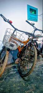 a bike with a basket parked next to a building at Blue Cove Villa Varkala in Varkala