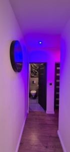 a purple room with a bathroom with a toilet at Apartament Na Rynku in Bytom