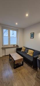 a living room with a couch and a coffee table at Apartament Na Rynku in Bytom