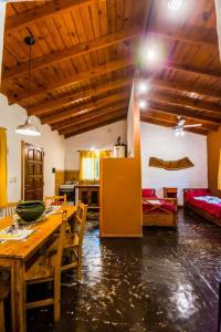 Una sala de estar con una mesa y una cocina. en Cabañas Atardeceres, en Capilla del Monte