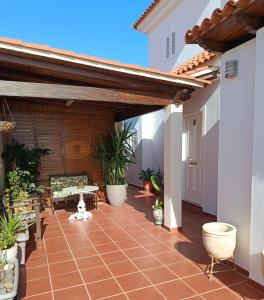 a patio with awning and plants in a house at Casa Chloe Jandía in Morro del Jable