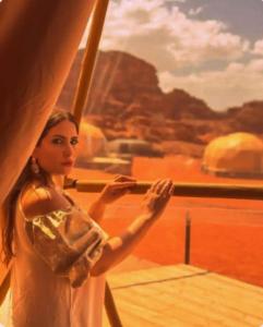 a painting of a woman standing on a ship at Olivia Rum Luxury Bubbles & Jeep Tours in Wadi Rum