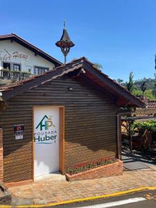 a building with a sign on the side of it at Pousada Huber in Treze Tílias +8 photos